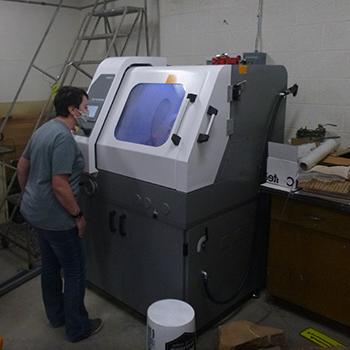 Student standing with equipment